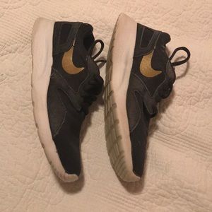 Grey and gold Nikes